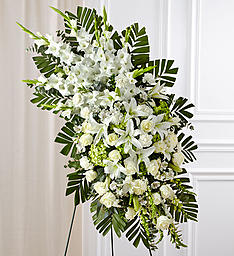 Tall white floral standing spray with palm fronds