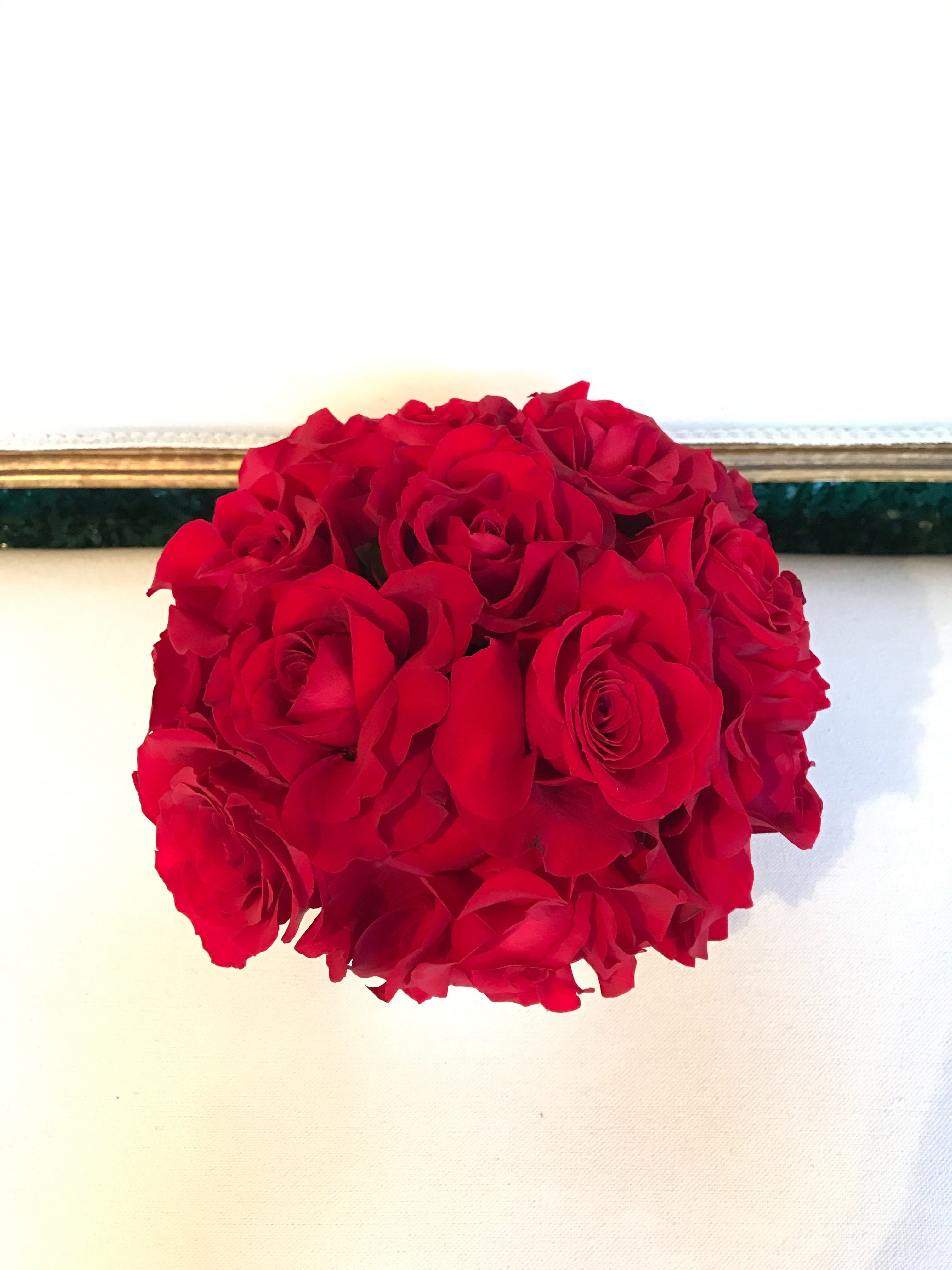Simply Elegant Roses - Classic Pave of red roses in modern vase. This arrangement is approximately 8x8 inches. Larger sizes available in upgrade "Deluxe" and "Premium" options.