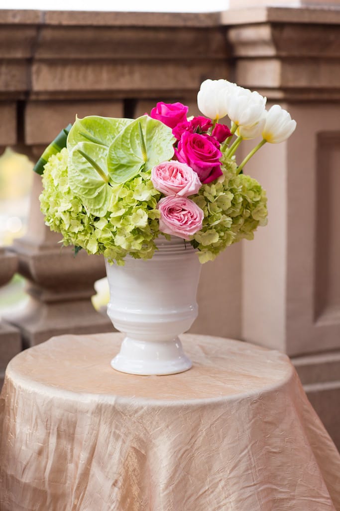 Pink and white roses with green hydrangeas in a white vase