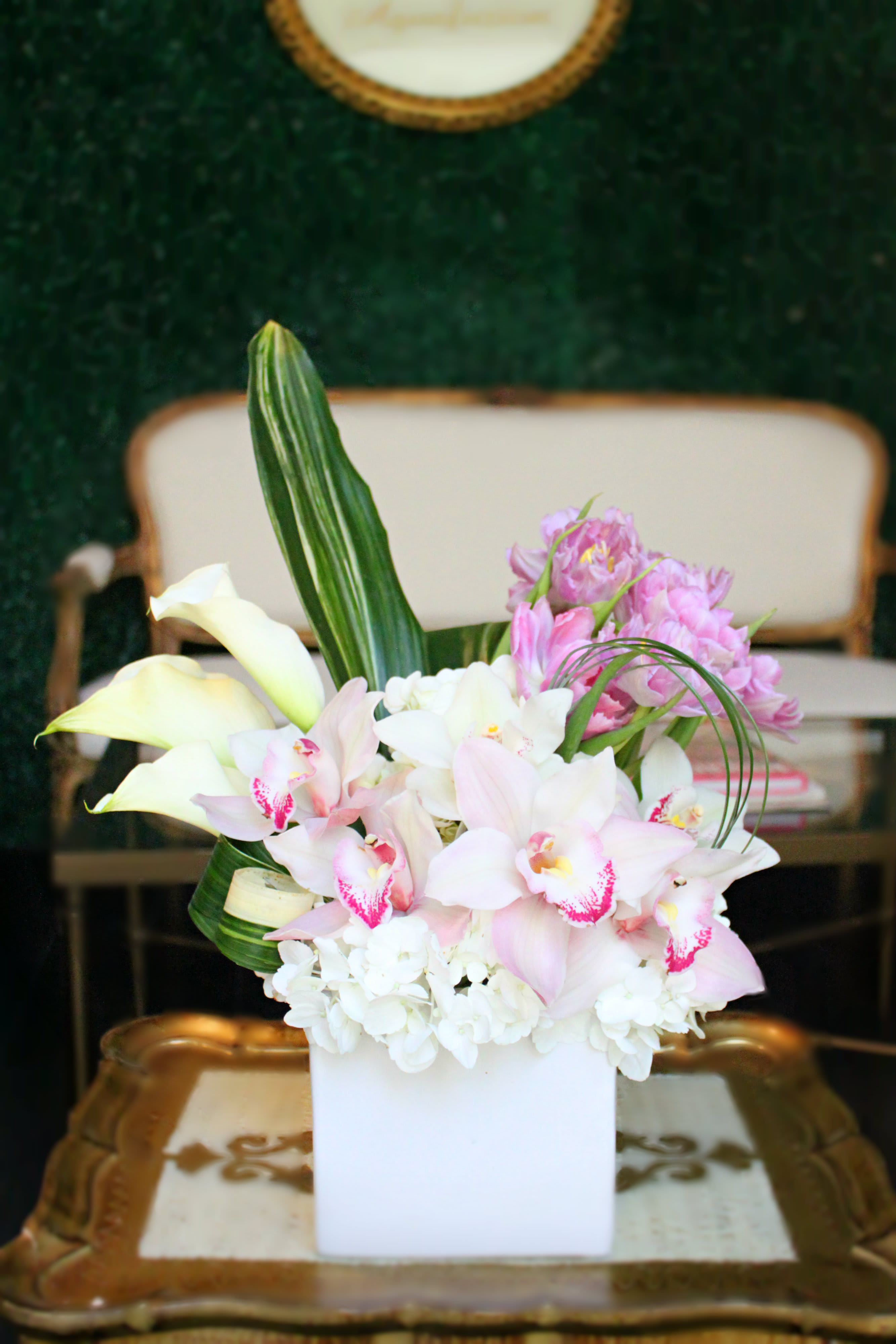 Pink and white floral arrangement in a white vase