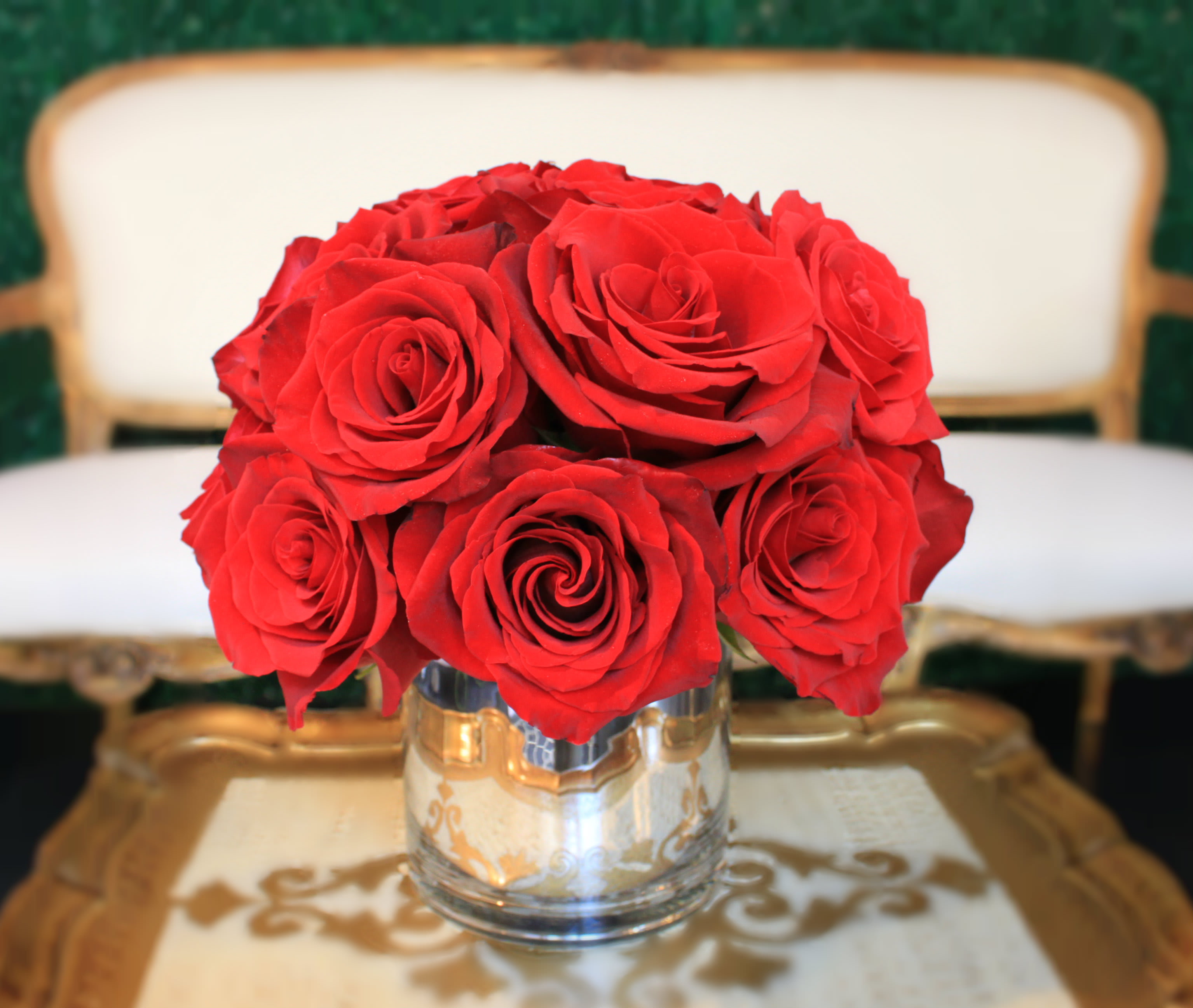 Red roses arranged in a clear glass vase