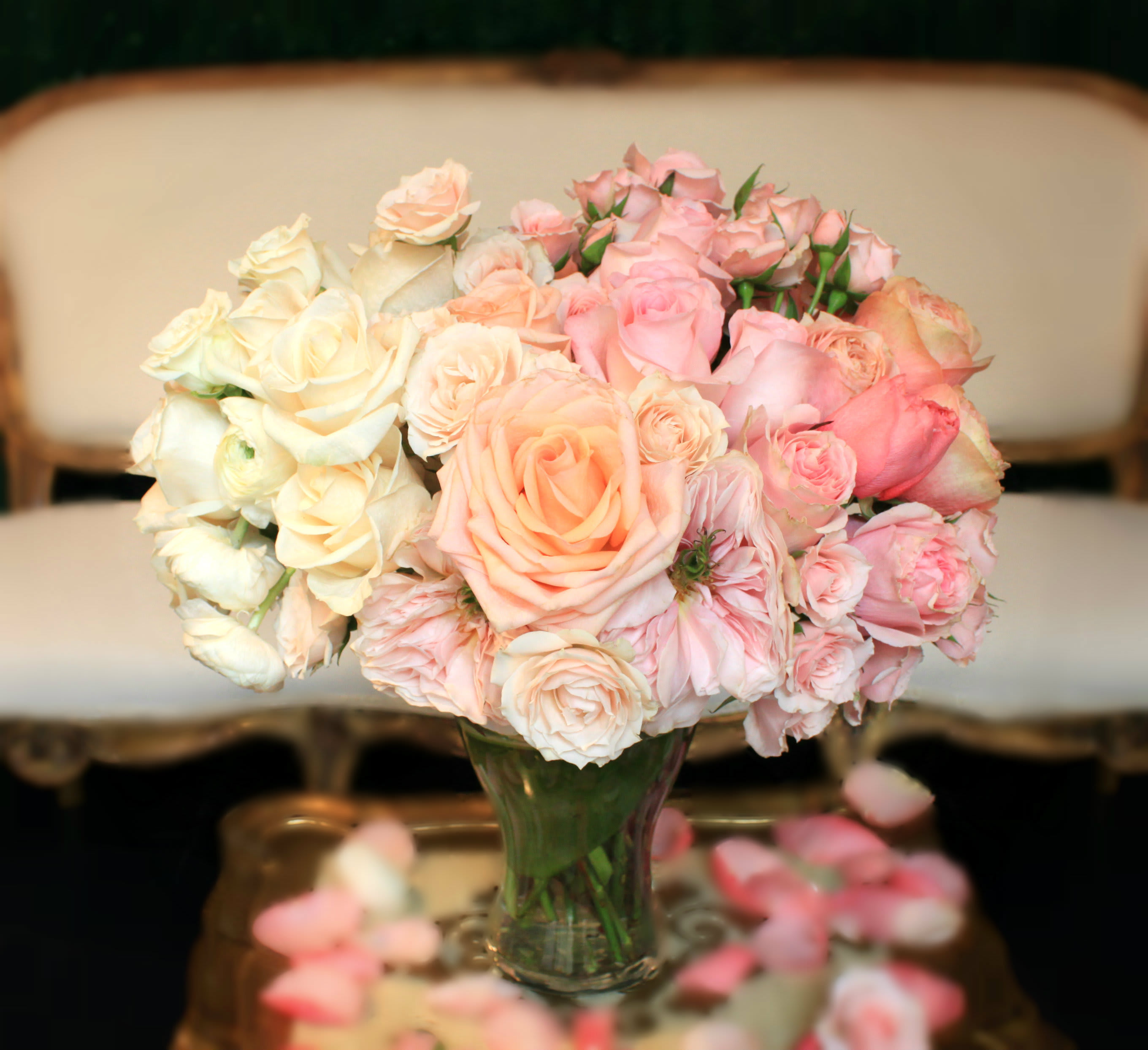 Bouquet of pale pink and cream roses in a clear glass vase