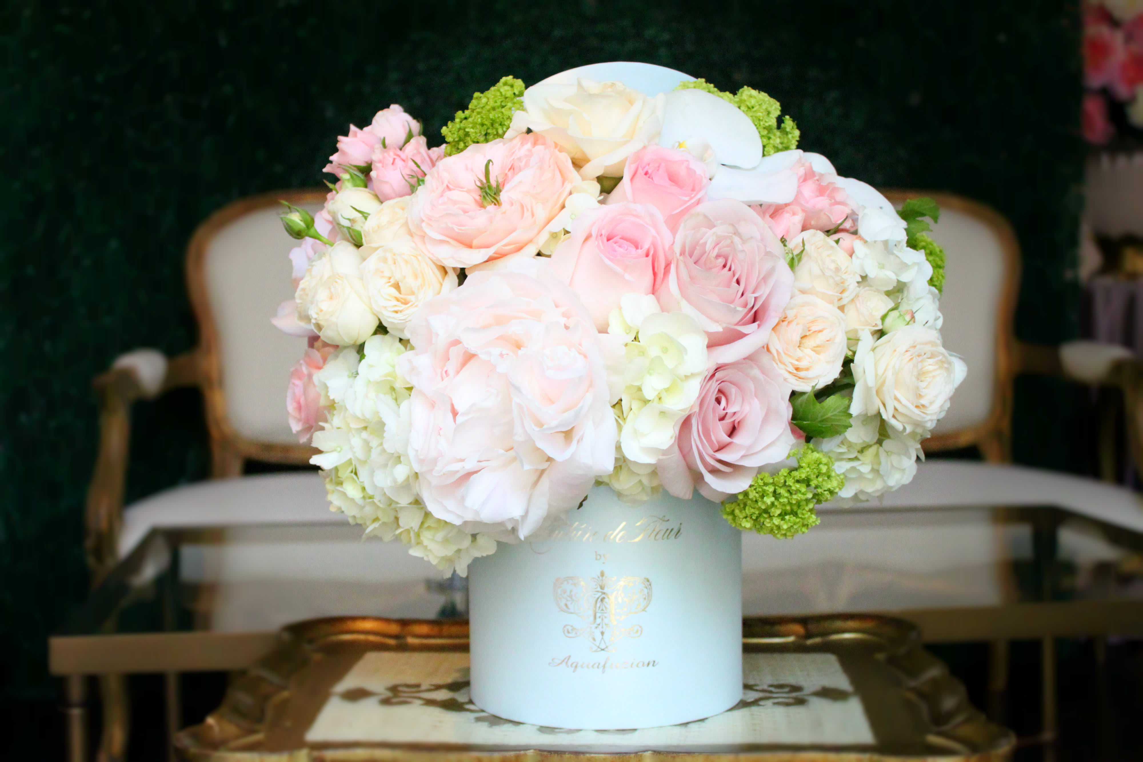 Pastel pink and white rose arrangement in a white hat box