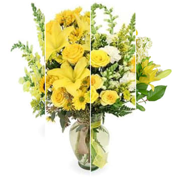 Yellow mixed flower bouquet in a glass vase