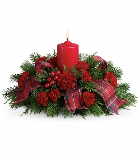 Red candle centerpiece with plaid ribbon and evergreen accents
