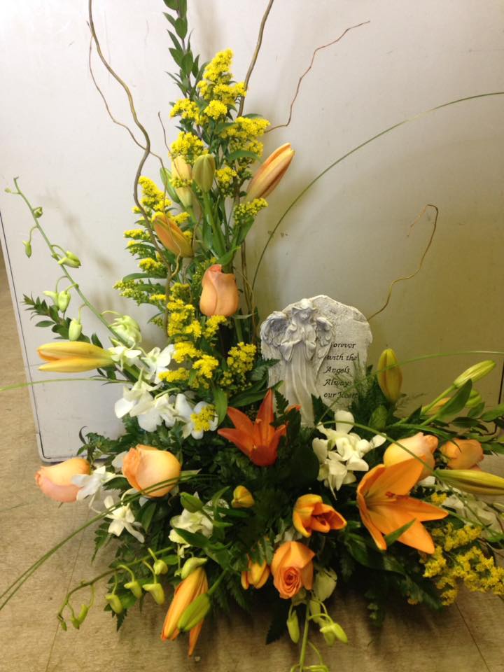 Orange Funeral  - Seasonal flowers with stone added. STONES AND FLOWERS MAY VARY DUE TO AVAILABILITY.
