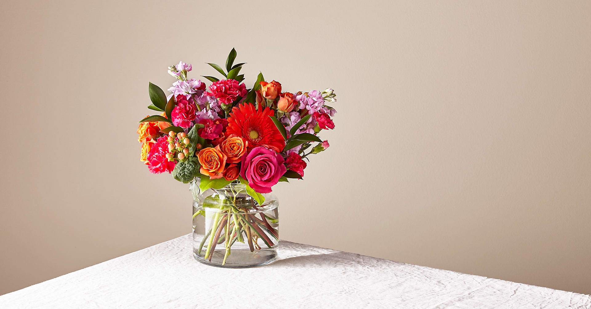 Fiesta Bouquet - The Fiesta Bouquet is composed of a lively mix, fit to celebrate any and every moment. With a combination of vibrant flowers, this florist–designed arrangement brings a pop of color and a burst of excitement as soon as it arrives. Complete with Carnations, Gerbera Daisy, Mini Spray Roses, Roses and Stock
