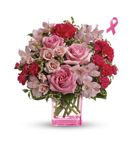 Pink roses and carnations in a pink glass vase with a breast cancer ribbon