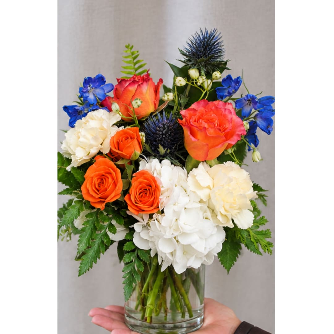 Bouquet of orange and white flowers in a clear glass vase