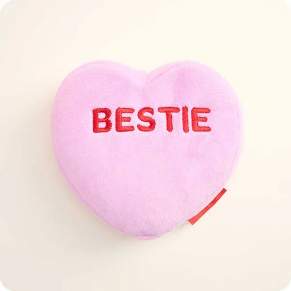 Pink heart-shaped plush with the word BESTIE embroidered on it