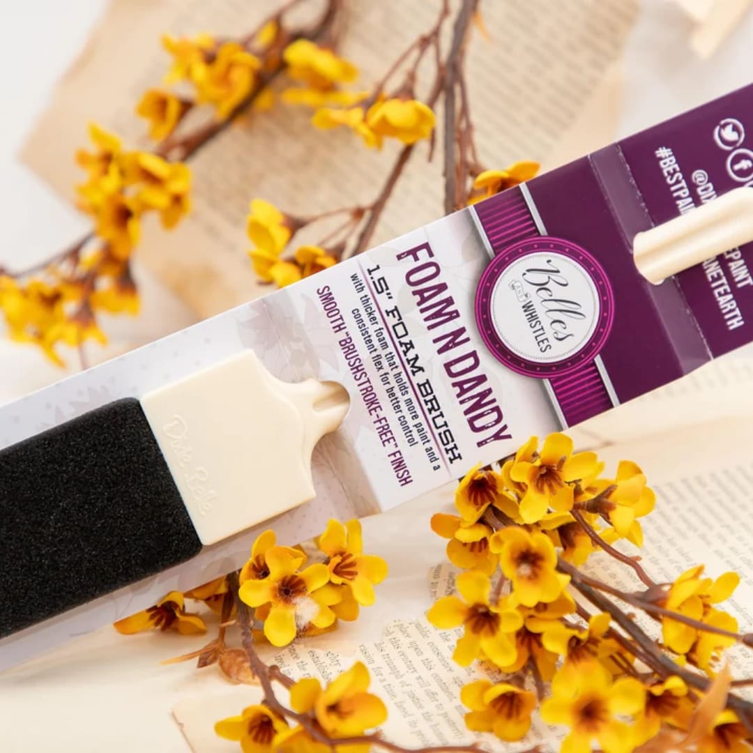 Foam paint brush with yellow blossoms and a purple package
