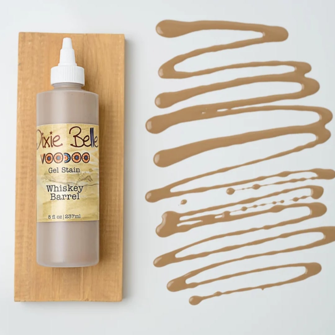 Bottle of Dixie Belle gel stain on a wood board with tan swatches beside it