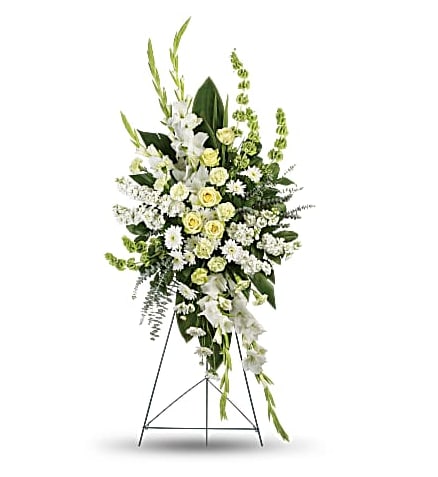 Sentiments of Serenity  - Beautifully simple, this lovely spray of white roses, lilies and carnations decorated with white satin ribbon is a tasteful way to express your sympathy. 