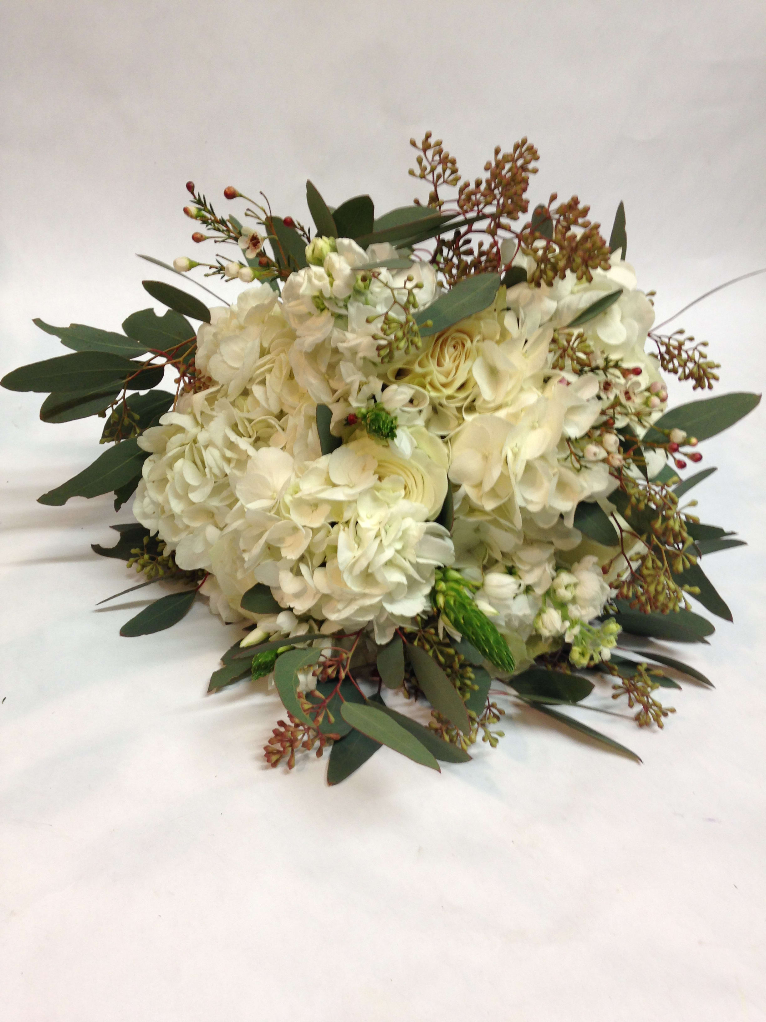 Textured and Sweet Bridal Bouquet (Pre-order) - Arrangement comes complete with a mix of white hydrangea, stars of Bethlehem, stock, and seeded eucalyptus. (Some flowers may be subject to change depending on the season. We will contact you with available flower substitutions; please contact us with specific questions if you are concerned with flower availability, thanks!)  Featured arrangement: $175.00 