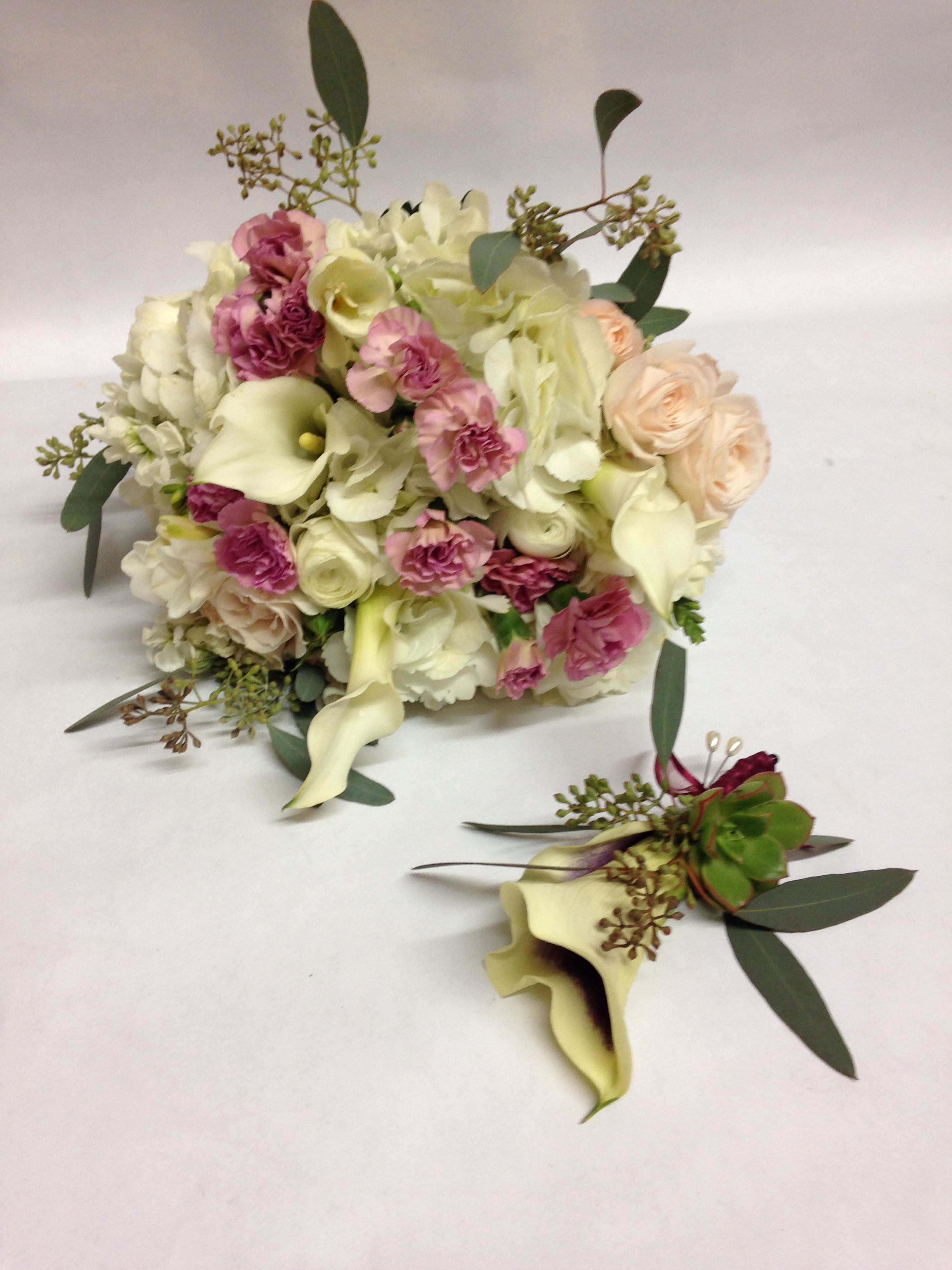 Affectionate and Blush Bridal Bouquet &amp; Boutinierre Duo (Pre-order) - This package comes complete with a bridal bouquet including white hydrangea, blush and pink spray roses/regular roses, seeded eucalyptus, mini carnations, stock, mini calla lilies, and ranunculus.  The boutinierre features a mini calla lily accompanied by a jade succulent bloom and seeded eucalyptus.  (Some flowers may be subject to change depending on the season. We will contact you with available flower substitutions; please contact us with specific questions if you are concerned with flower availability, thanks!)  Featured duo: $225.00 (Regular Price)