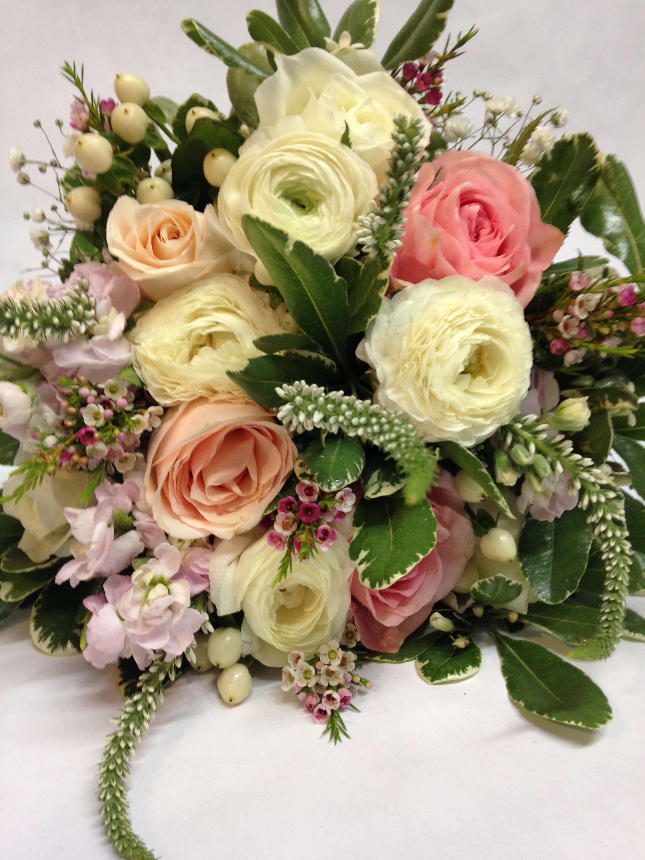 Bouquet of pink and cream roses with white ranunculus