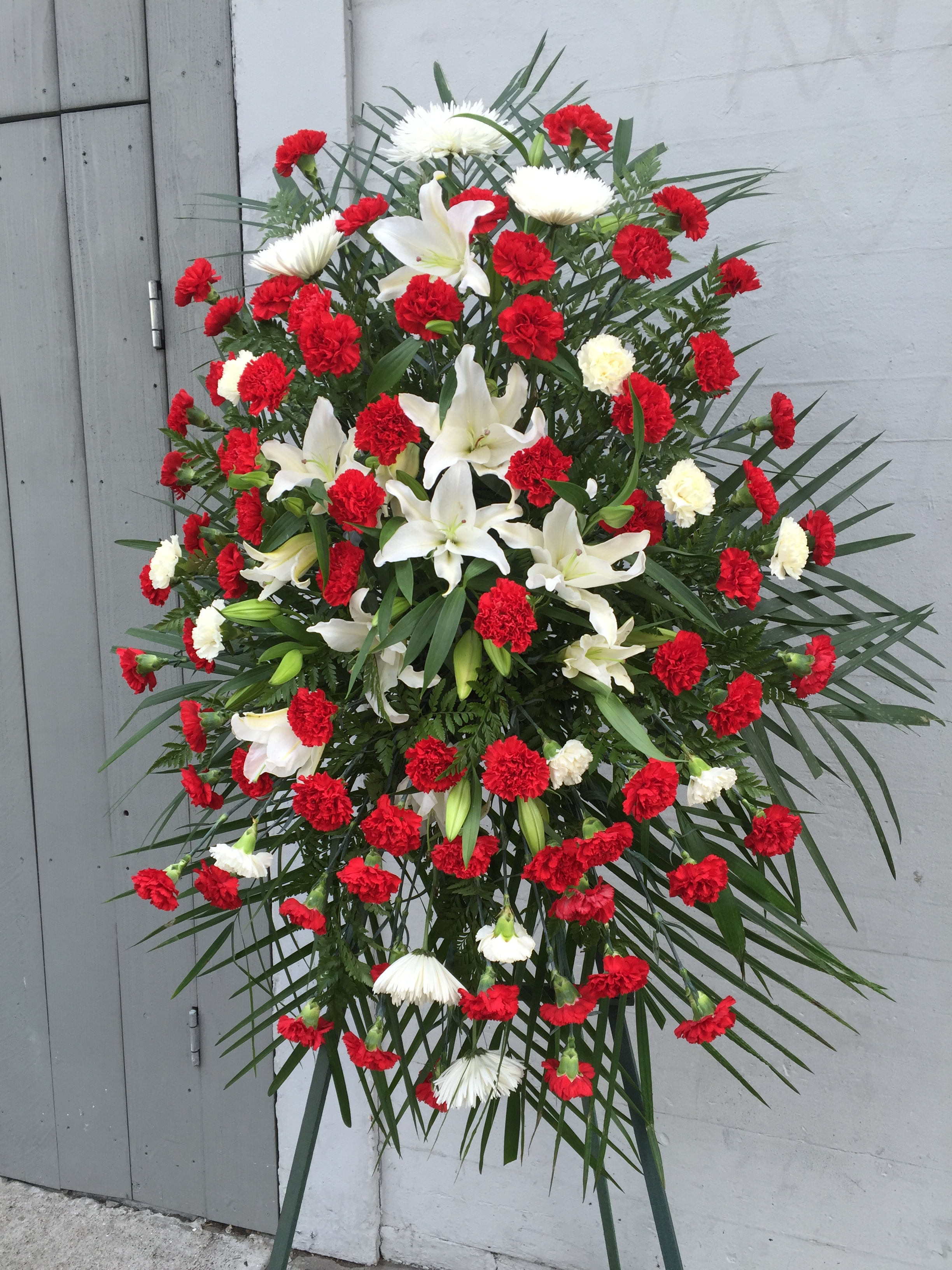 Standing floral spray with red carnations and white lilies