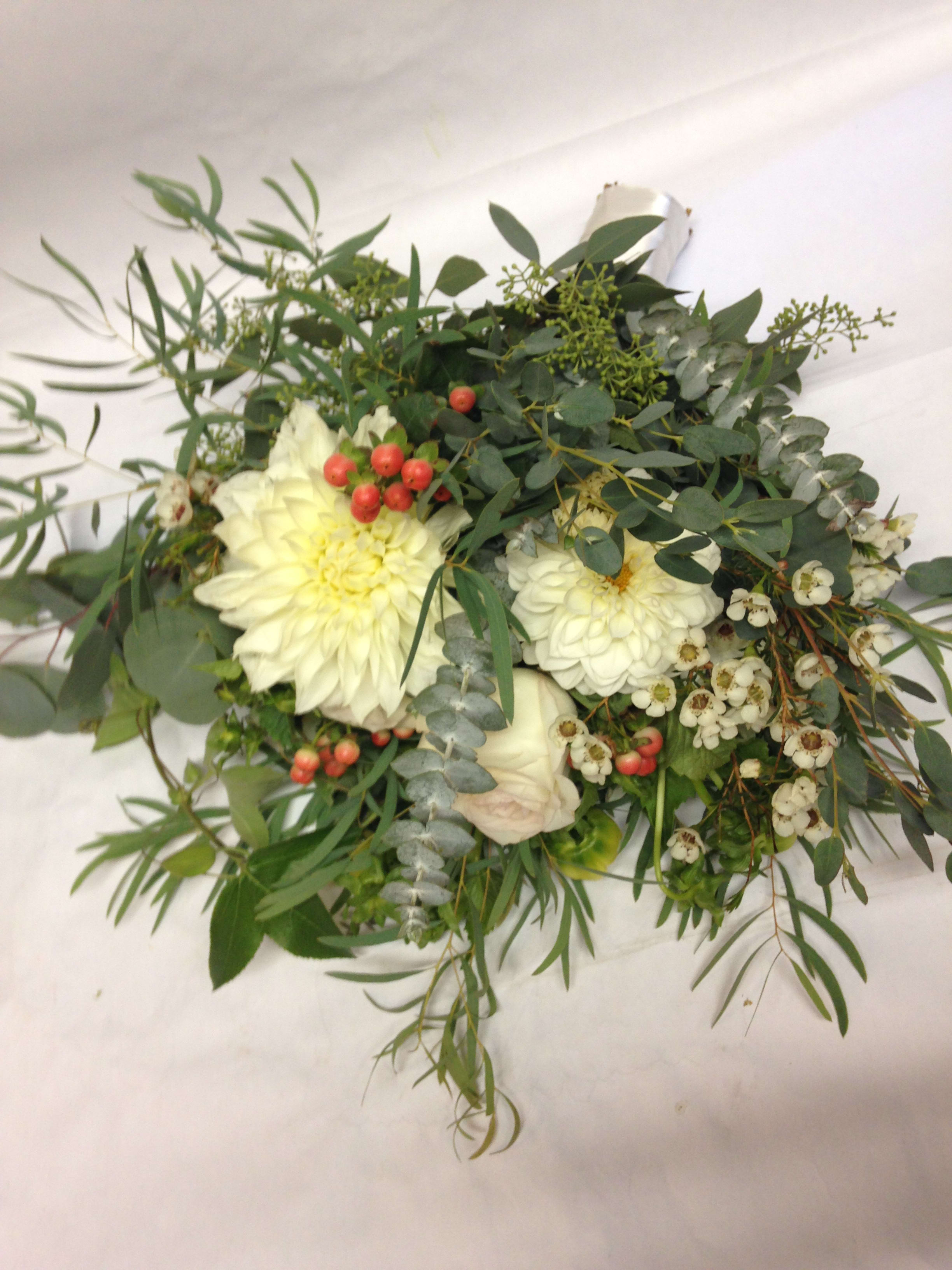 White flower bouquet with greenery and red berries