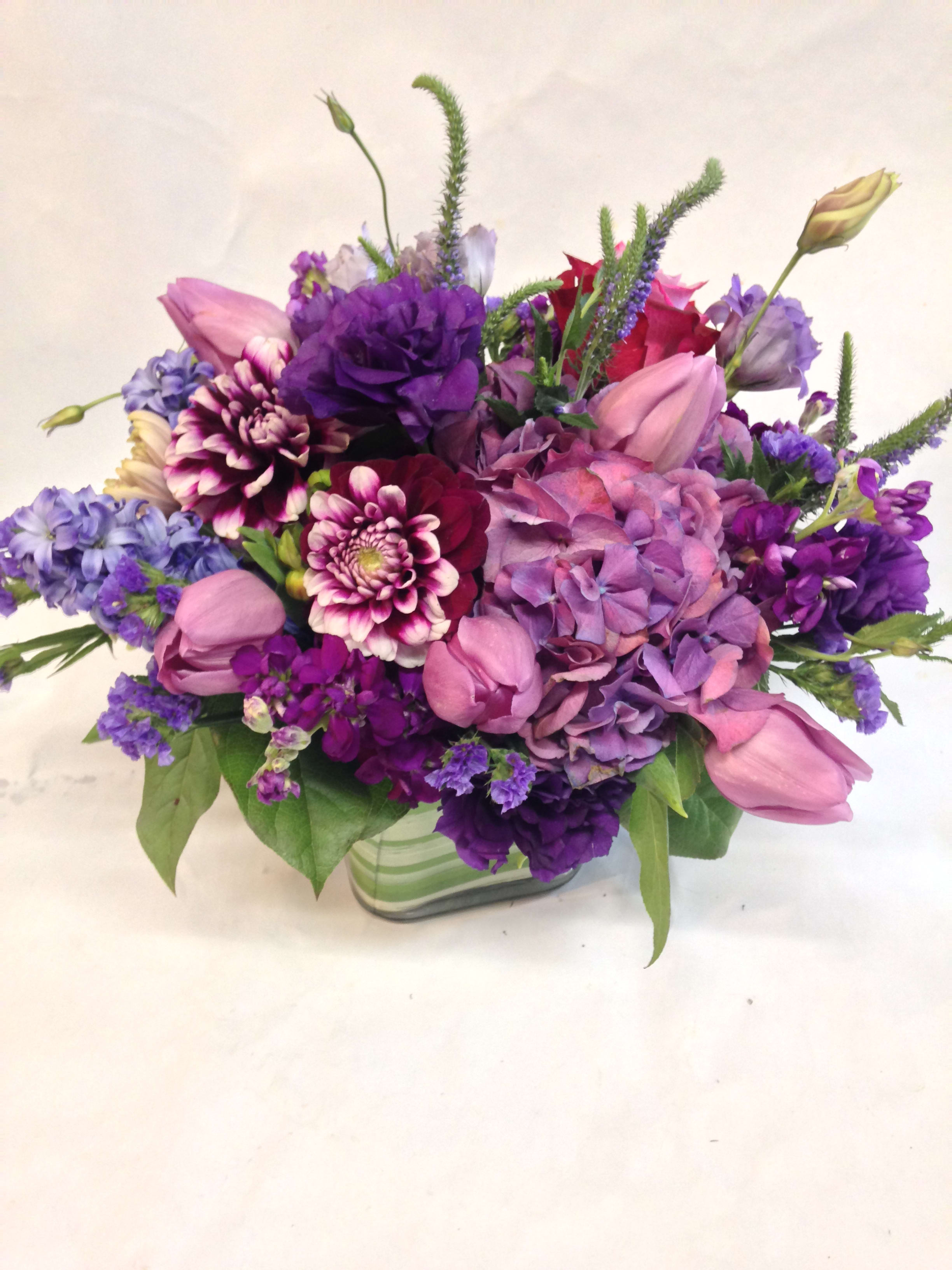 Purple and pink mixed bouquet in a glass vase