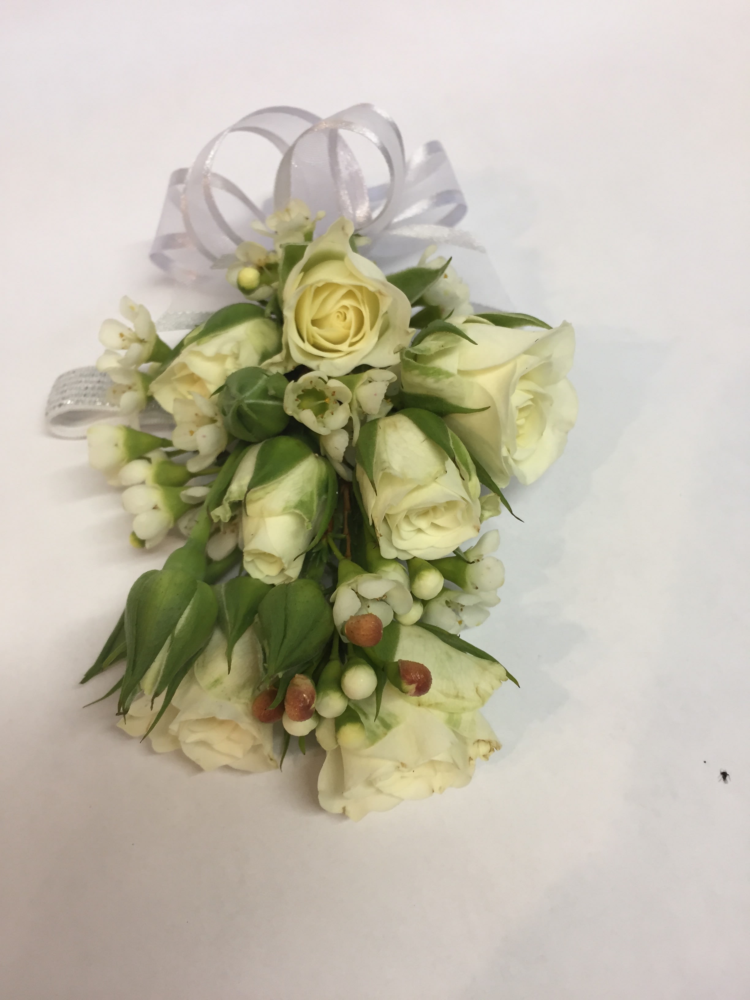 Small white rose corsage with ribbon loops