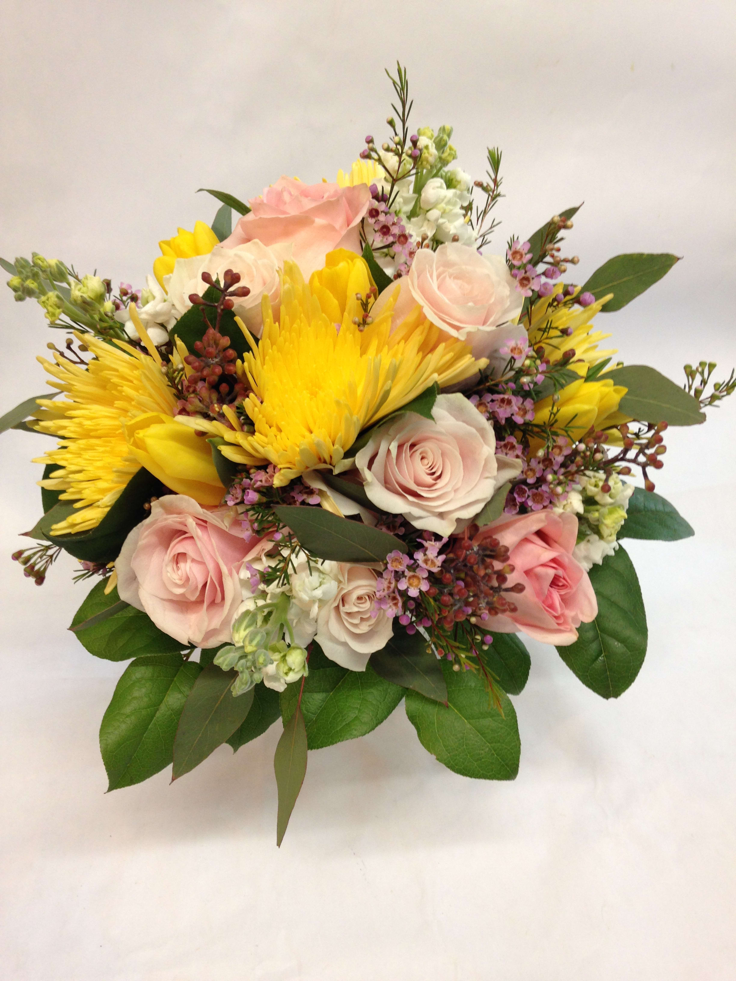 Bouquet of pink roses and yellow chrysanthemums with greenery