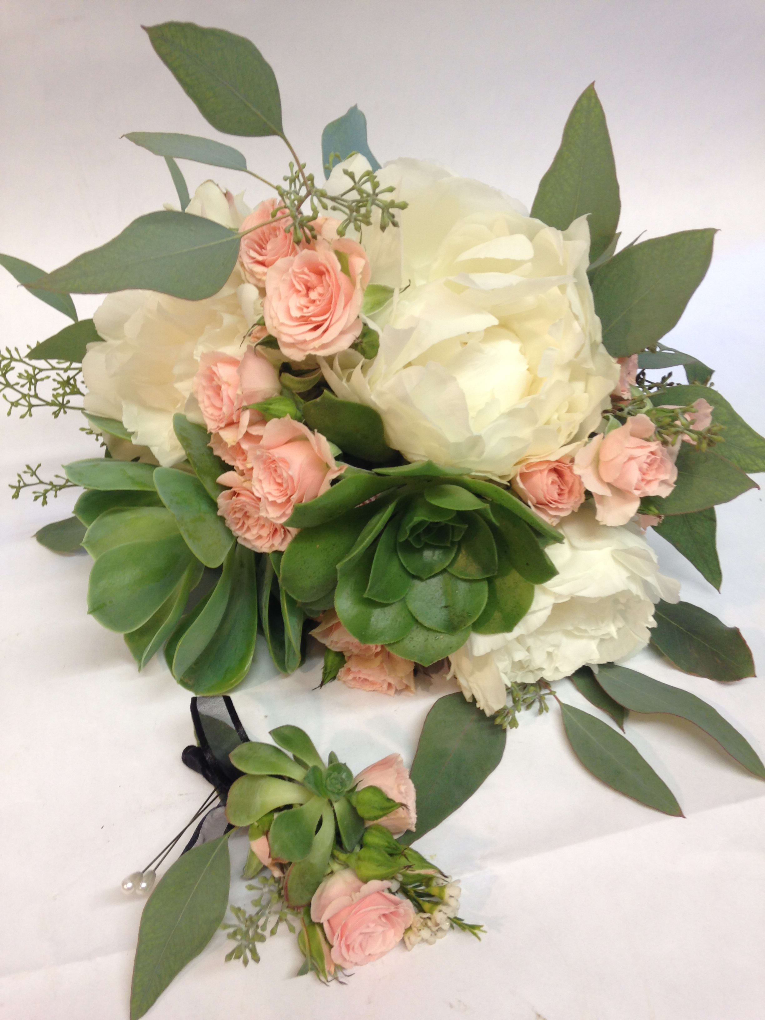 Bouquet of white peonies and pink spray roses with succulents