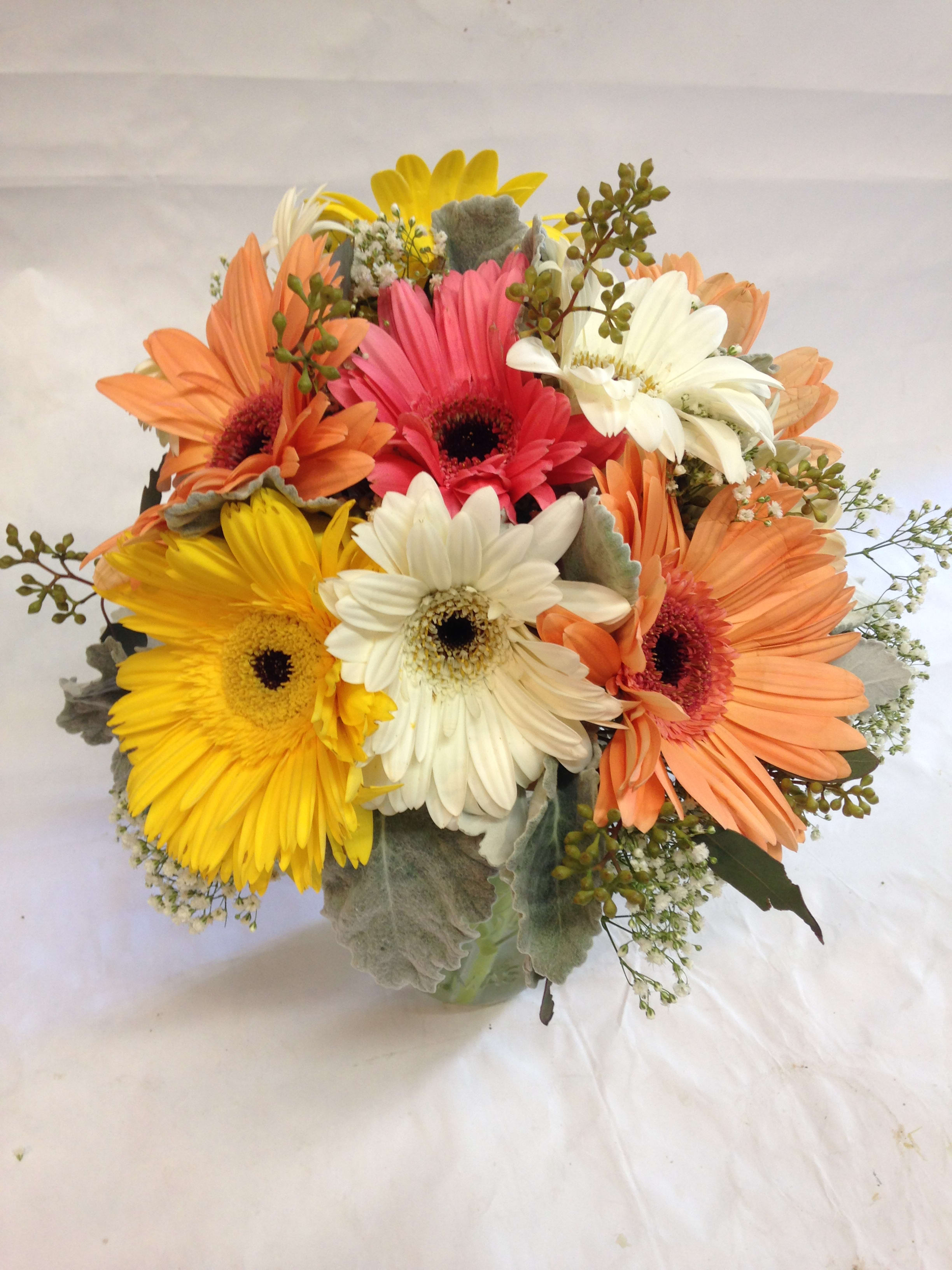Bouquet of colorful gerbera daisies in a glass vase