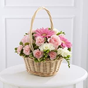 Basket of pink and white flowers with a tall handle
