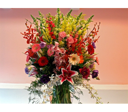 Her Majesty - W226 - This is an arrangement designed for BIG events or BIG surprises. This is one of the largest arrangements that our designers have created. It is made with Stargazer Lilies Larkspurs Dendrobium Orchids Mini Cymbidium Orchids Gerbera Daisies Roses Dahlia and Lisianthus in a large cylindrical glass vase.Dimensions Approximately: 45"H x 20"W As Shown : W226