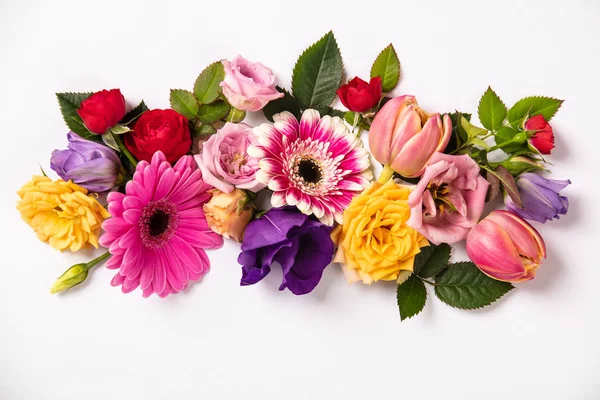 Mixed bouquet of roses, gerbera daisies, and tulips in pink, yellow, and purple