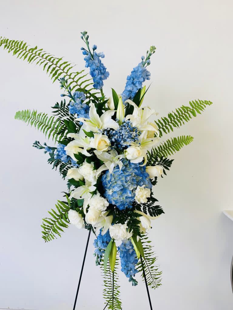 Tall blue and white floral standing arrangement on an easel