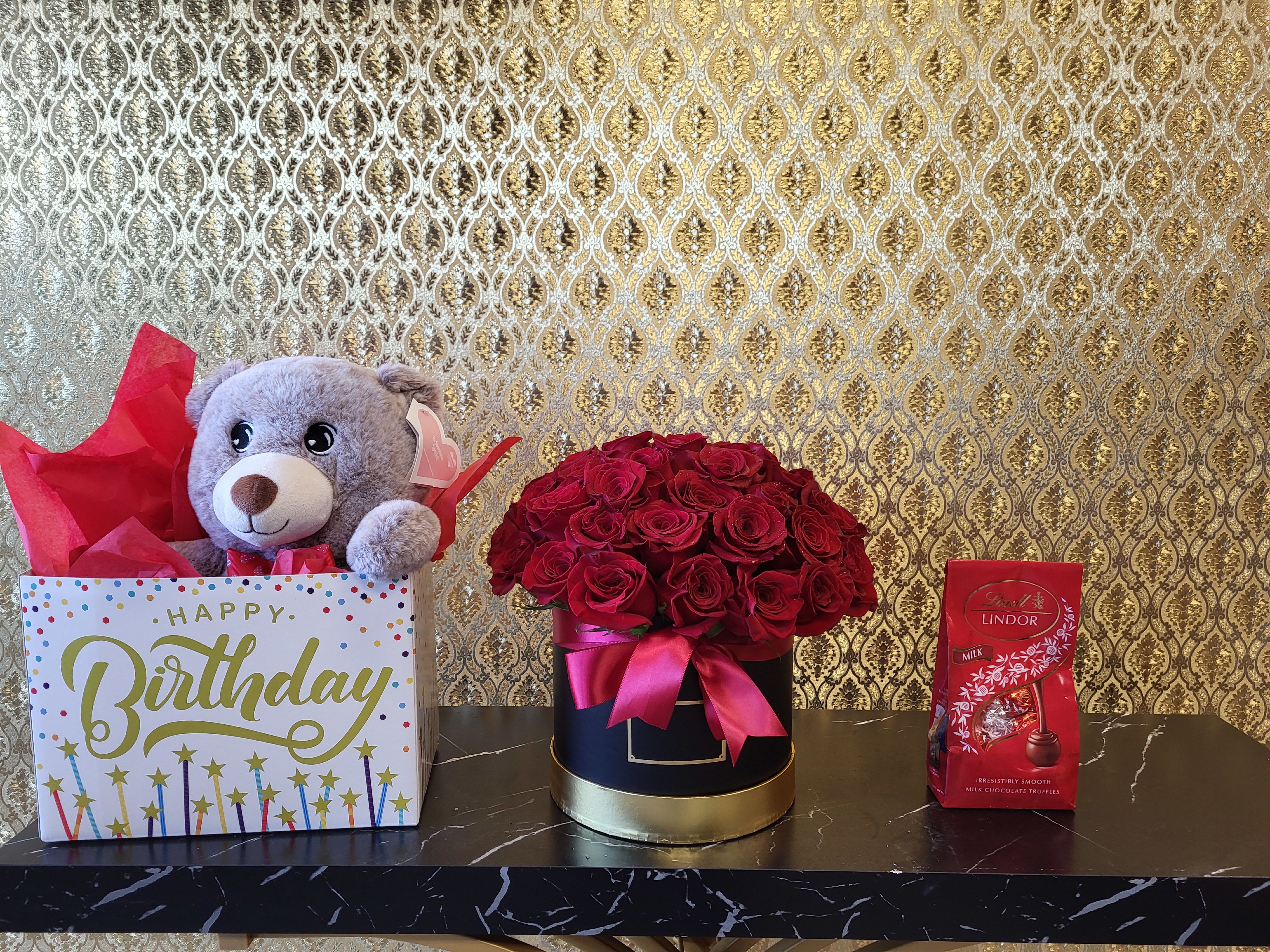 Birthday gift box with teddy bear, roses, and chocolates
