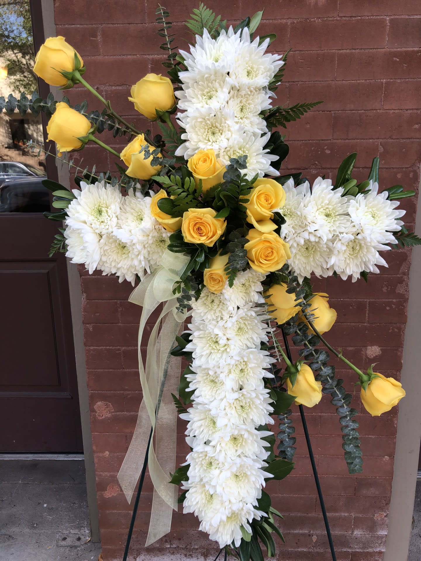 Cross-shaped floral spray with white chrysanthemums and yellow roses