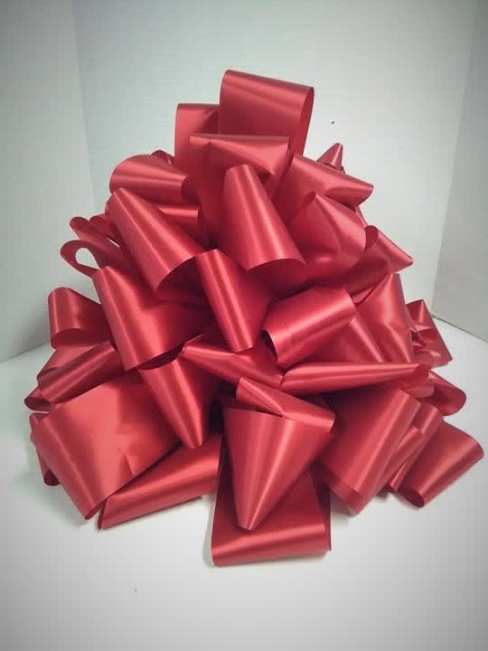 Large red gift bow on a white background