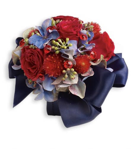 Red roses and blue flowers arranged with a navy ribbon