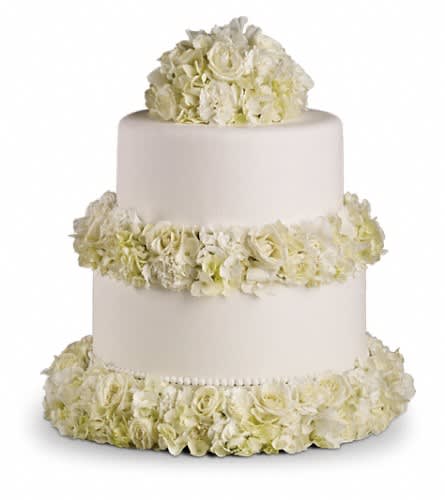 Three-tier white cake decorated with white flowers