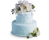Two-tier light blue cake with white floral decorations