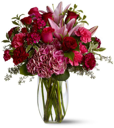 Pink and red mixed bouquet in a clear glass vase