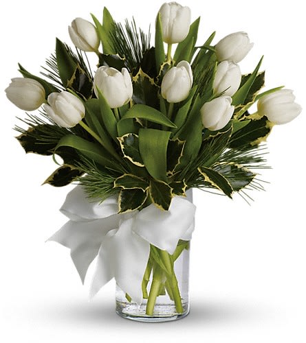 White tulips arranged in a clear glass vase with a white ribbon