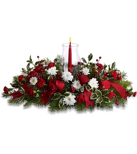 Christmas centerpiece with red candle, white flowers, and ribbon