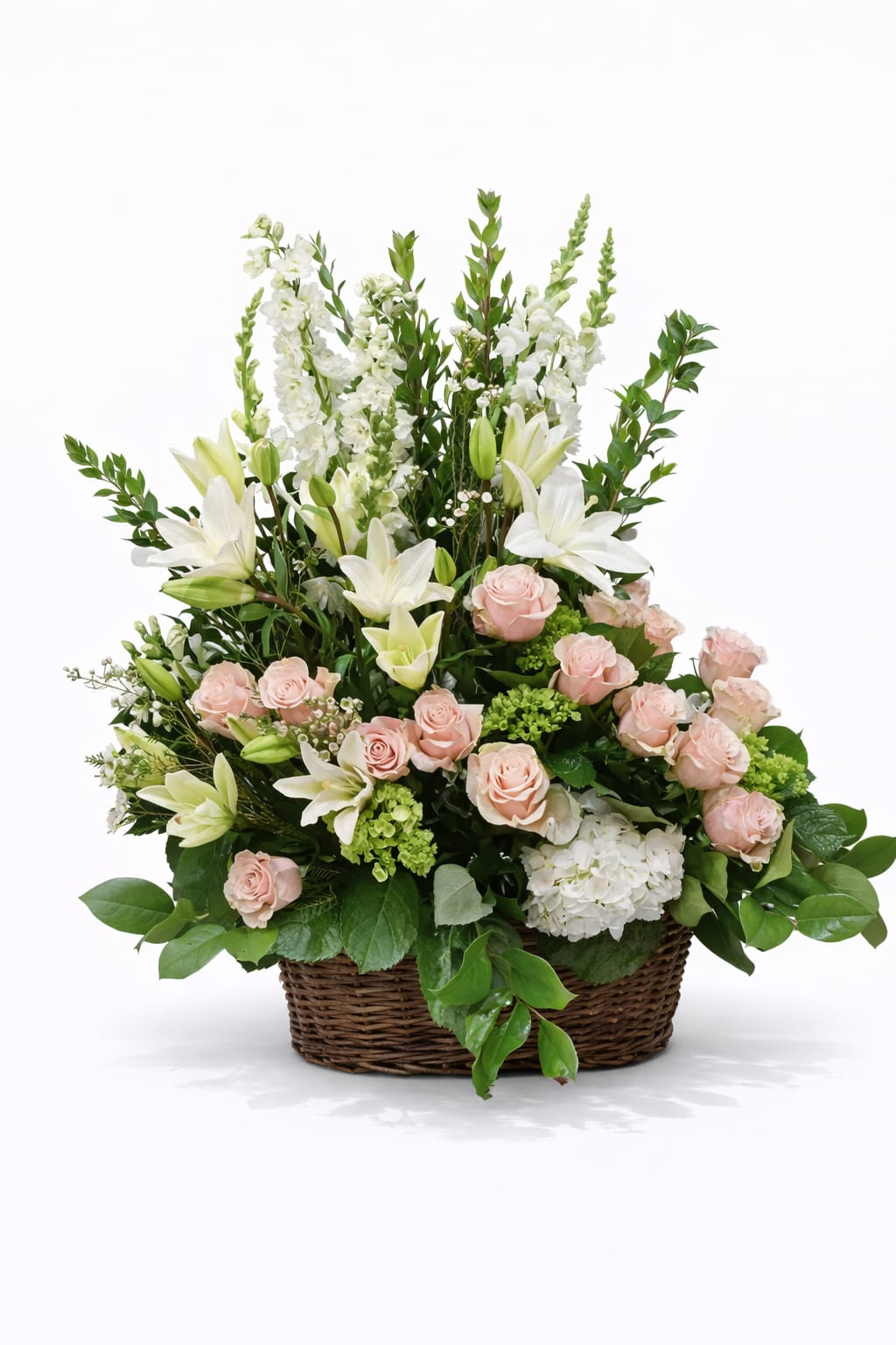 Basket arrangement of pink roses and white lilies with tall white blooms