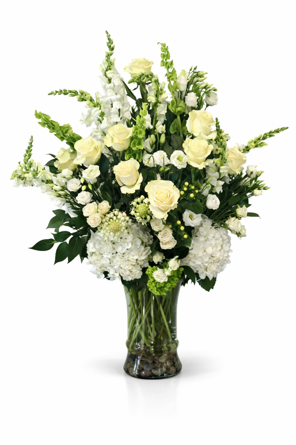 White and pale yellow floral arrangement in a glass vase