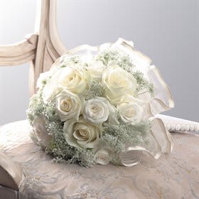 White rose bouquet with baby's breath on a chair
