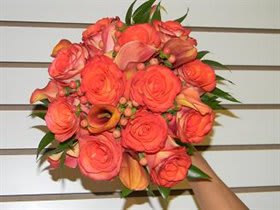 Coral rose bouquet with calla lilies and greenery