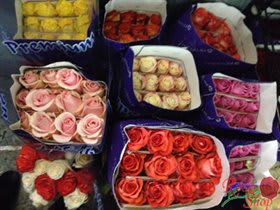 Assorted bouquets of roses in purple wrapping