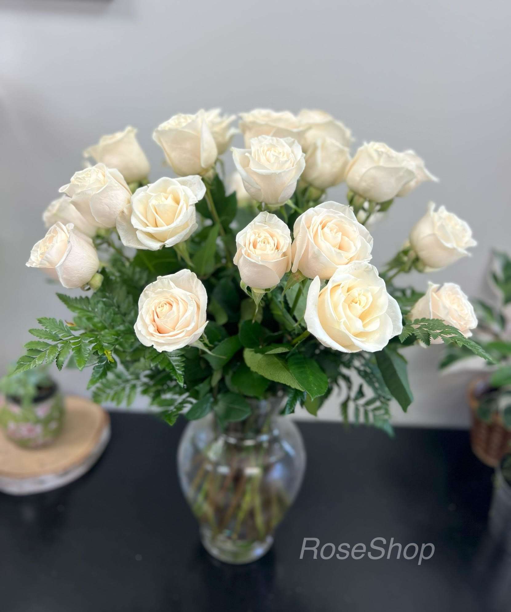 Cream roses arranged in a clear glass vase
