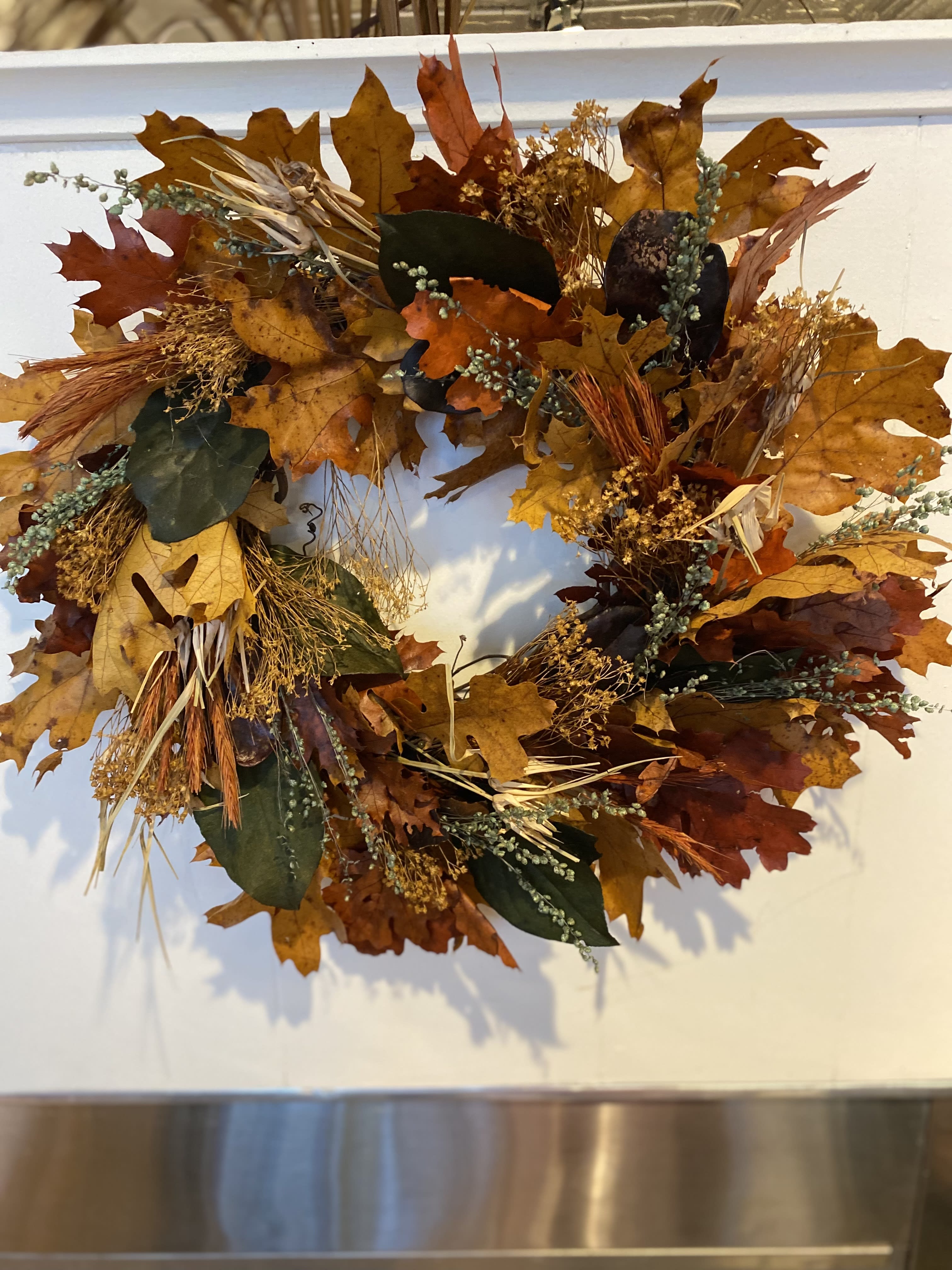 Autumn Greetings - A beautiful 16" wreath with dried and preserved leaves and assorted pods and grasses.  A wonderful accent to any ones home.  