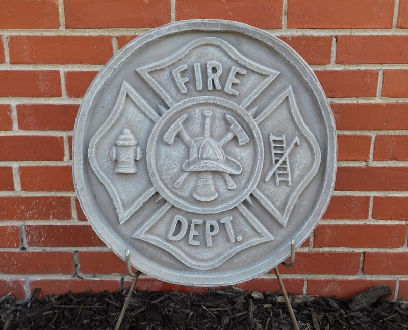 Fire department emblem plaque mounted on a brick wall