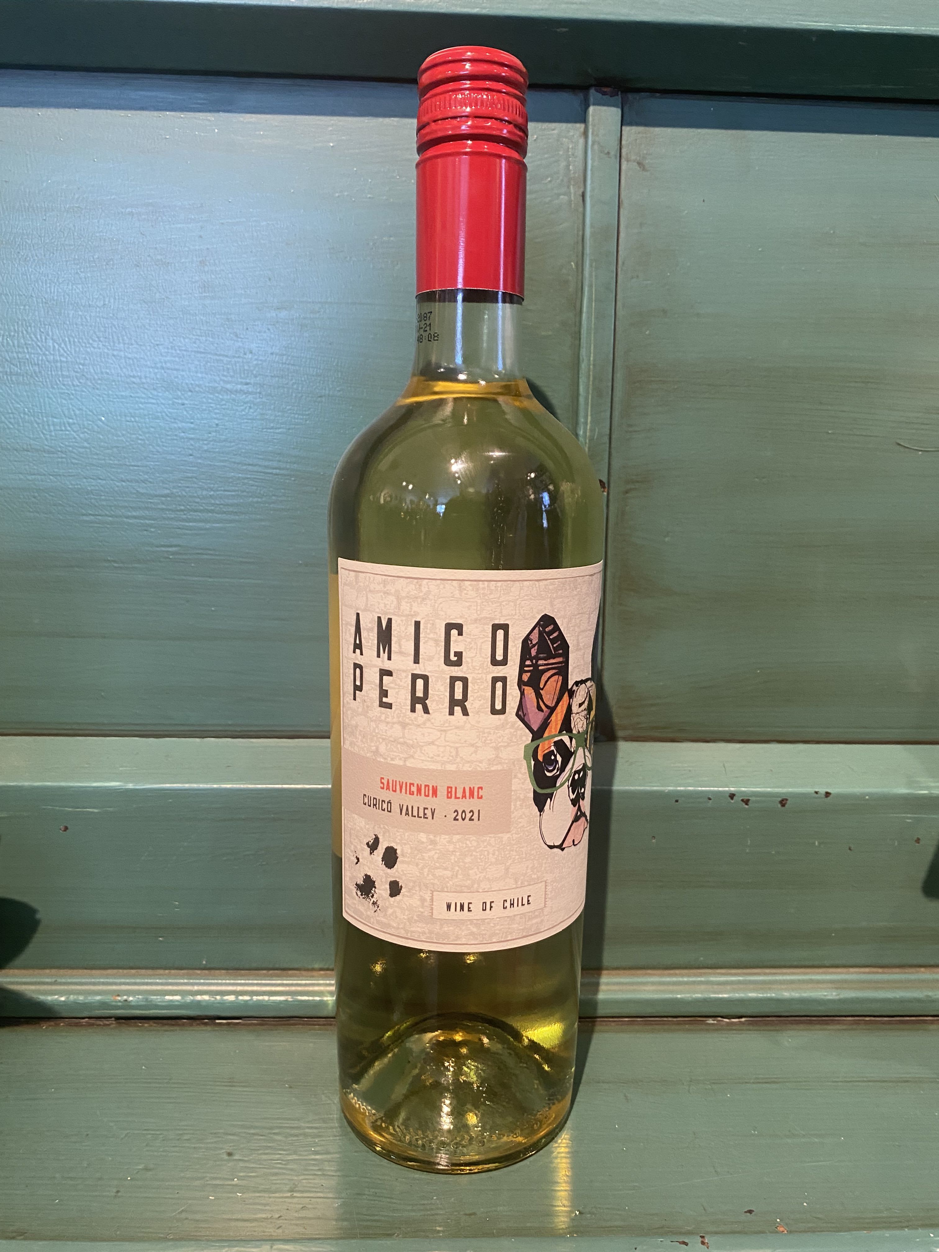Bottle of white wine with a red cap and label