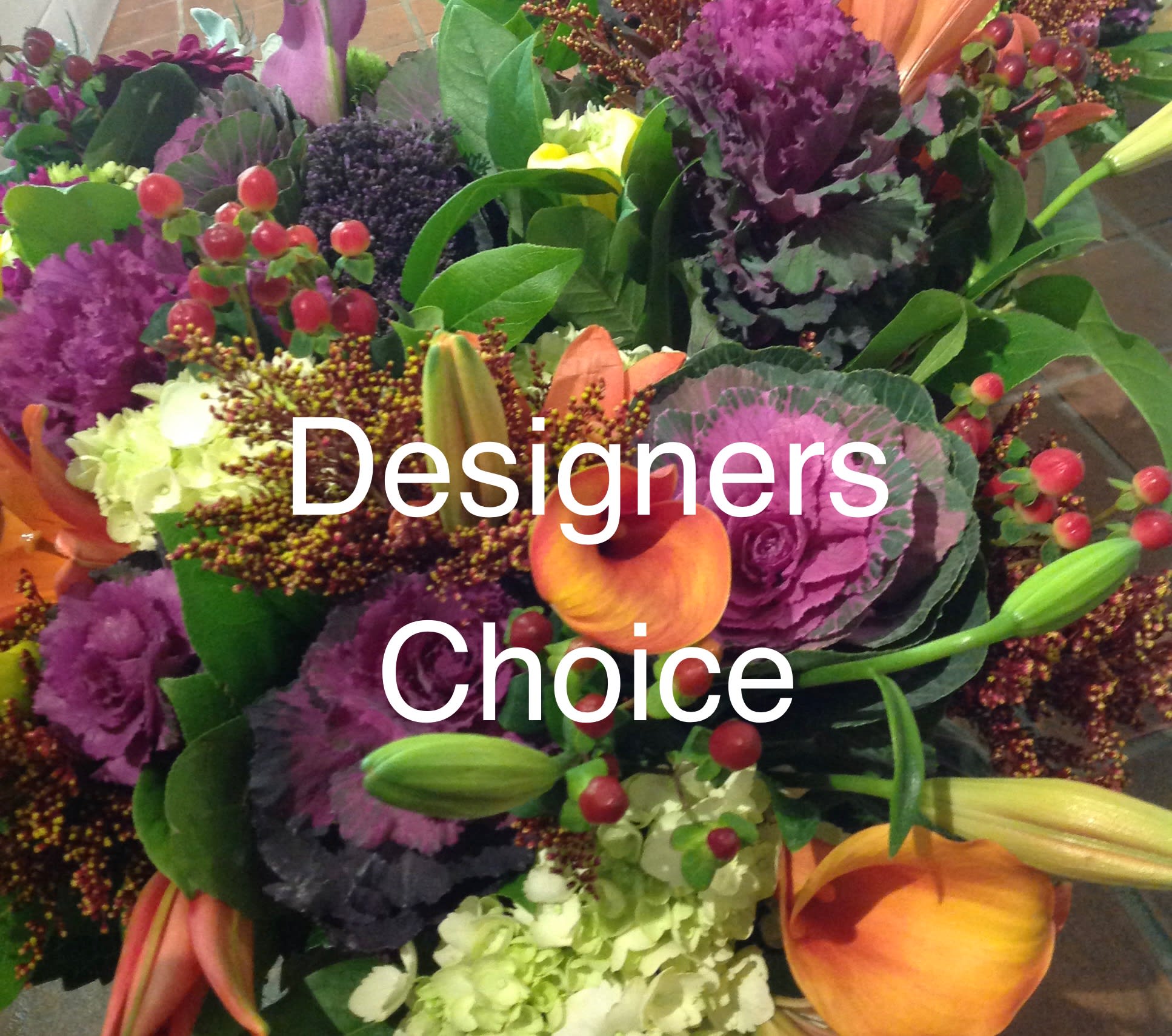 Colorful mixed bouquet with purple ornamental cabbage, orange calla lilies, and green hydrangea